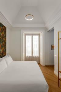 A bed or beds in a room at Be Mate Málaga Centro