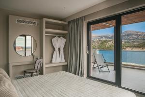 a bedroom with a bed and a view of the ocean at The Twelve Suites Collection in Argostoli