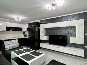 a black and white living room with a couch at TEA Apartments in Pomorie