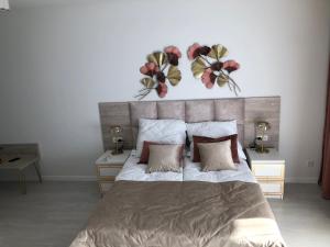 a bedroom with a large bed with flowers on the wall at Rogowo Pearl 1510 in Rogowo