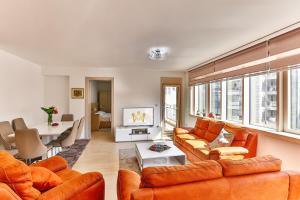 a living room with orange furniture and a table at Luxury Fontana Apartments in Budva