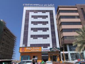 a tall building with a sign on top of it at OYO 109 Al Thabit Modern Hotel Apartment in Ḩayl Āl ‘Umayr