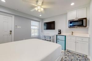 a bedroom with a bed and a ceiling fan at Sweet Studio Suite in Rockport