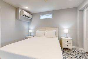 a bedroom with a large white bed and two lamps at Sweet Studio Suite in Rockport