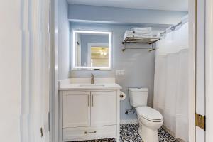 a bathroom with a toilet and a sink and a mirror at Sweet Studio Suite in Rockport