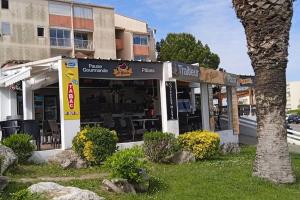 a restaurant in front of a building at Studio - 2min Mer & Plages - Grau du Roi in Le Grau-du-Roi