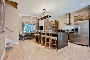 a kitchen with a counter and a bar with stools at Magic Views Villa in Orlando
