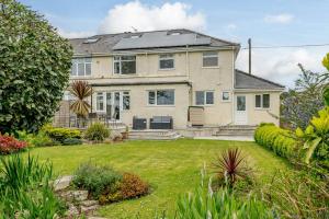 a large house with a lawn in front of it at Caradoc in Chepstow