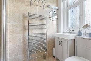 a bathroom with a shower with a toilet and a sink at Captains Cottage - Stylish cottage, level location, in the heart of Dartmouth in Dartmouth +17 photos