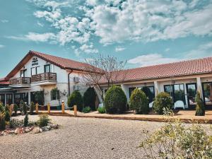 a large white house with a red roof at Vila Medusa in Vama Veche
