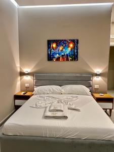 Un dormitorio con una cama con un cuadro en la pared. en Hotel Real, en Ishull-Lezhë