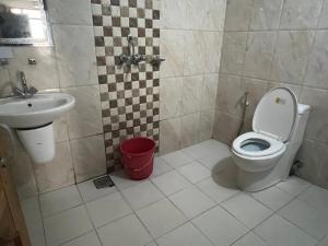 a bathroom with a toilet and a sink at Holy Land Hotel Nepal in Kathmandu