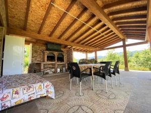 a dining room with a table and chairs and a fireplace at Casa Rural El Bohío CA-846-AS in Arriondas