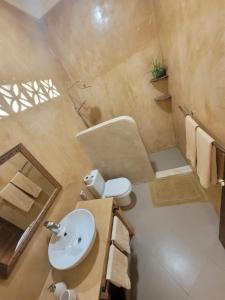 a bathroom with a sink and a toilet at Siri Beach Lodge in Nungwi