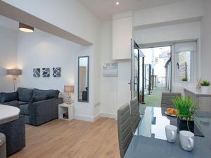 a living room with a couch and a table at 1 primrose mews in Torquay