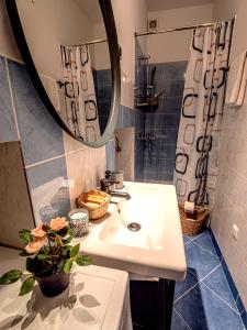 a bathroom with a sink and a mirror at Artini Apartments Piran in Piran