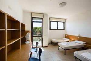 a hospital room with a bed and a window at Ostello Ipsia in San Benedetto del Tronto