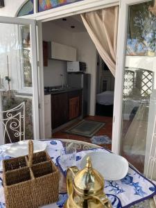 a kitchen with a table with a tea kettle and a table sidx sidx at Arabesque in Lacco Ameno