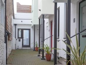 an alley with potted plants in a building at 1 primrose mews in Torquay