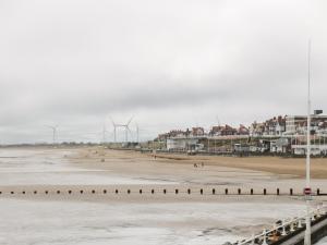 a view of the beach with windmills in the background at Reggie's Place in Bridlington