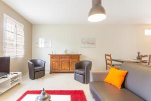 un salon avec un canapé, des fauteuils et une table dans l'établissement Maison Baduel, à Auxey-Duresses