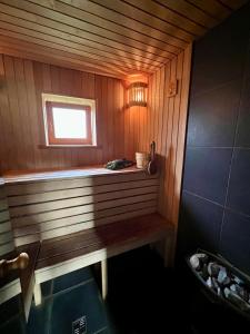 a sauna with a bench and a window in it at Stella in Ziemupe