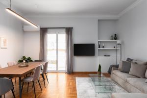 a living room with a table and a couch at KASO - Fotomara in Athens