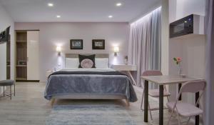 a bedroom with a bed and a table and chairs at ERMIS in Ioannina