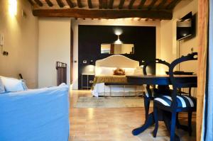 a bedroom with a bed and a table with a chair at suite la fortezza in Montalcino