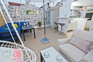 a room with a hammock and a living room at Sweet Dreams Old Town Hvar in Hvar