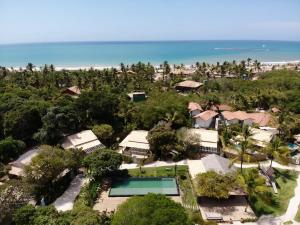an aerial view of the resort and the beach at Villa dos Nativos Boutique Hotel in Trancoso