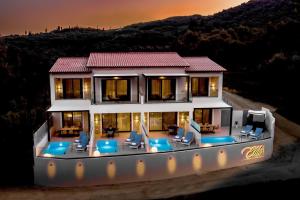 an aerial view of a house with chairs and tables at Elite Luxury Villas in Parga