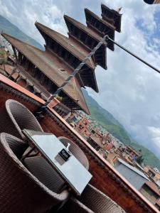 a chair with a piece of paper sitting on top of a building at Hotel Empire & Rooftop Restaurant in Bhaktapur