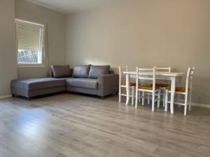 a living room with a couch and a table at Panorama Apartments in Tirana