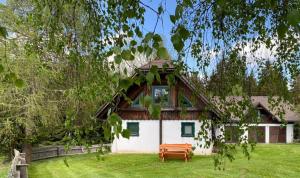 a house with a bench in front of it at FERIENHAUS WALDTRAUM in Sankt Veit an der Glan