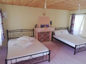 a room with two beds in a room at North Evia Kiki's house in Kourkouloí