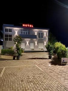 a hotel with lights on the side of a building at Hotel Real in Ishull-Lezhë