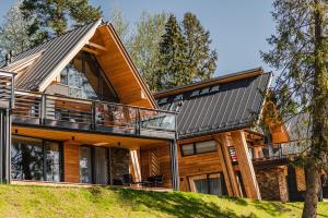 a log home with a metal roof at Rezydencja Boutique SKI - 200m do Term Bania Odkryj Białkę in Białka Tatrzanska