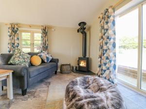 a living room with a couch and a fireplace at Acorn Lodge in Stafford