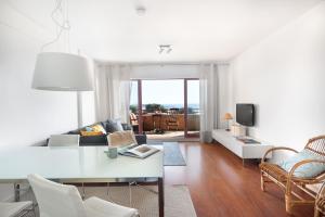 a living room with a couch and a table at Own Places - Ocean View Apartment in Matosinhos