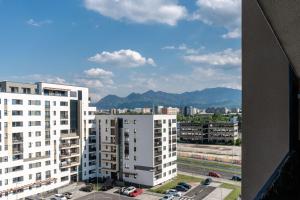a view of a city with tall white buildings at Apart B&V 701 in Braşov