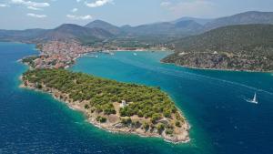 an island in the water with a boat in it at Lovely 2-bedroom apartment in the heart of Ermioni in Ermioni