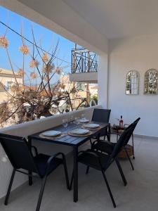 a dining room with a black table and chairs at Lovely 2-bedroom apartment in the heart of Ermioni in Ermioni +8 photos