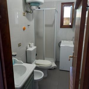 a bathroom with a toilet and a shower and a sink at Casa Debby in Palau