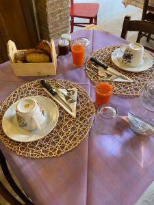a purple table with plates and utensils on it at Agriturismo Poggio alla Luna in Gerfalco