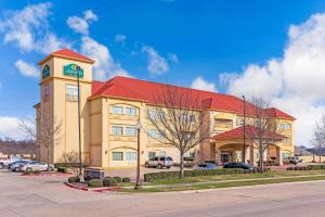 a building with a clock tower on top of it at La Quinta by Wyndham Ennis in Ennis