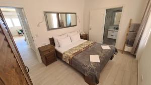 a small bedroom with a bed and a mirror at Apartments Tanja in Zavalatica
