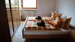 Un dormitorio con una cama con dos objetos negros. en Haus Knabl/Wölzing, en Wölzing