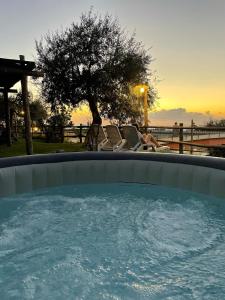 a woman sitting in a chair in a hot tub at L'antica Pigna Chateau in Vico Equense