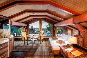 a living room with a bed and a table at Wellnesshotel Seeschlößchen - Privat- Spa & Naturresort in Senftenberg